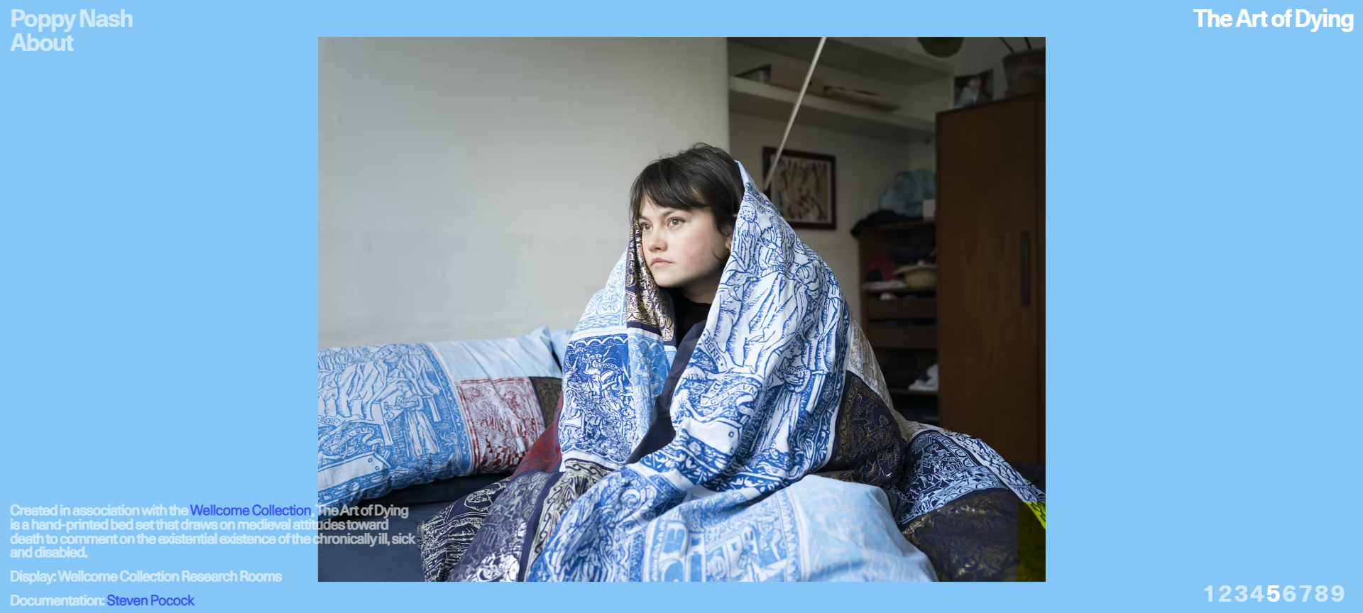 a picture of Poppy huddled underneath her hand printed duvet, she is looking off into the distance with a sad expression on her face.