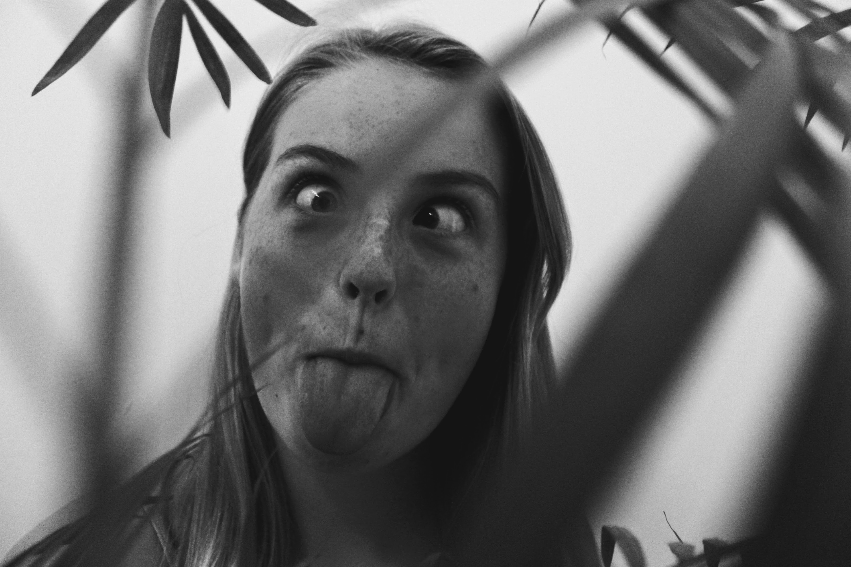 an image of a teenage girl who has freckles. She has crossed her eyes and stuck her tounge out.